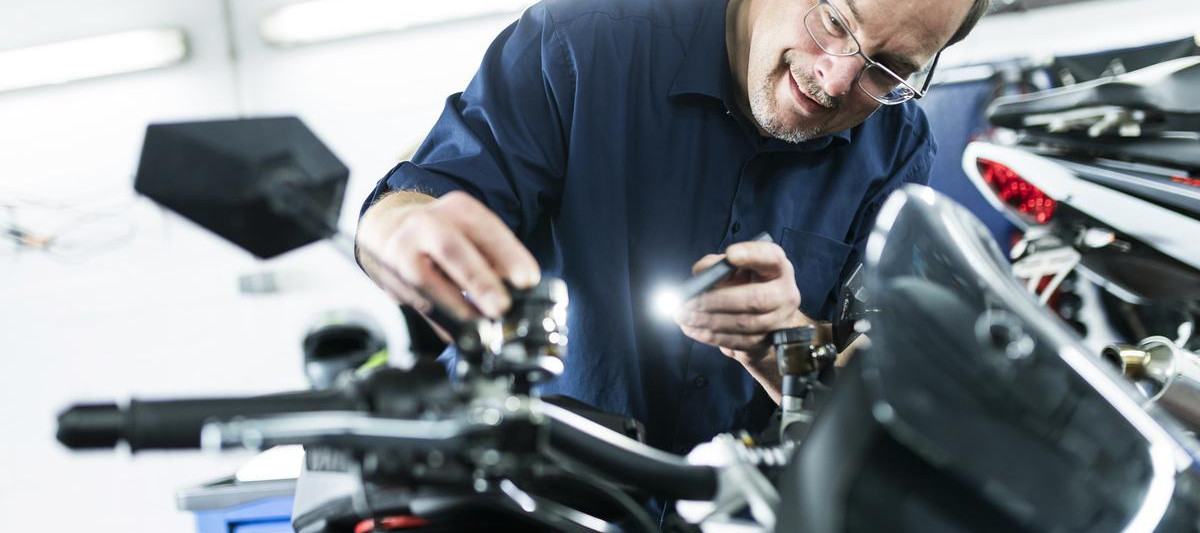 Ein Mann untersucht ein Motorrad