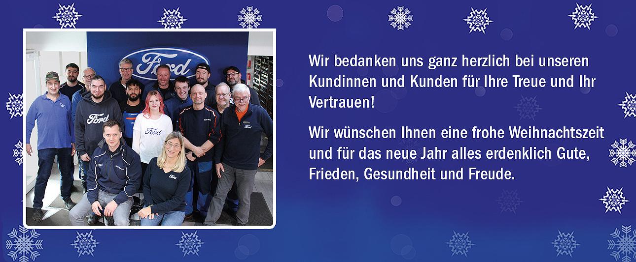 Gruppenbild Auto Vest auf blauem Hintergrund mit Schneeflocken platziert und Text mit Weihnachtswünschen